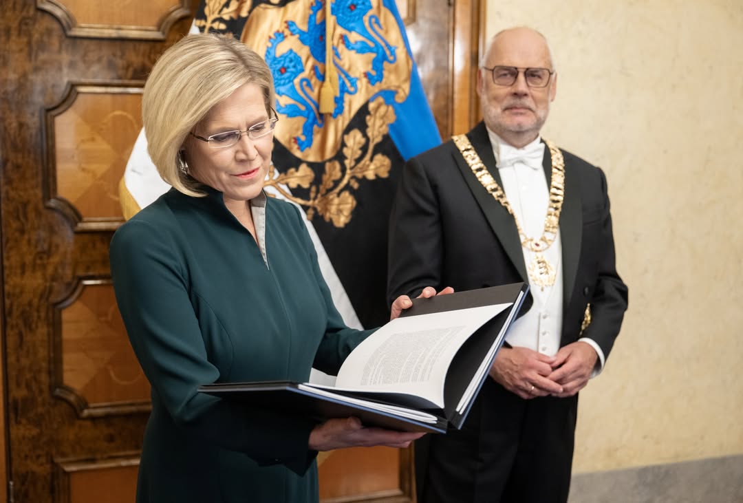 President Ülle Madise holding the open volume of constitutions at the inauguration ceremony